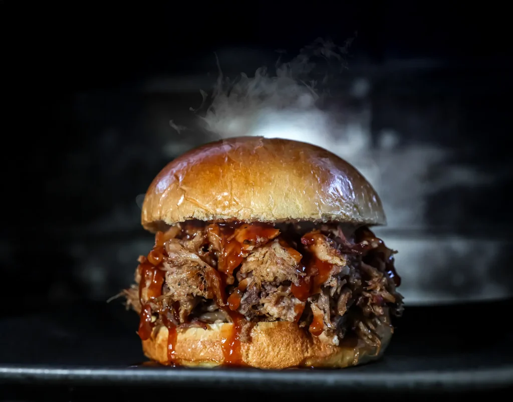 Silver Platter's best pulled pork sandwich is shown slathered with BBQ and delicious seasonings. Just heat and eat!